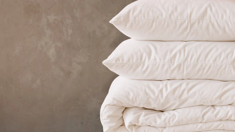 stack of pillows and a quilt
